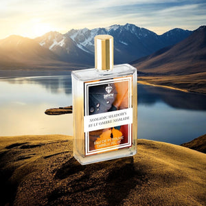 LV Ombre Nomade fragrance bottle with gold cap displayed on rocky landscape with mountains and lake background